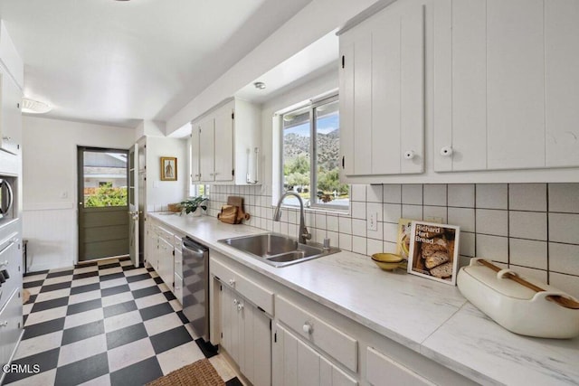 921 Topaz Ct, Ojai, CA 93023 - kitchen with stainless steel dishwasher, a sink, light floors, and light countertops