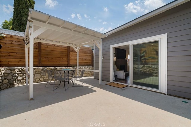 view of patio with fence and outdoor dining space