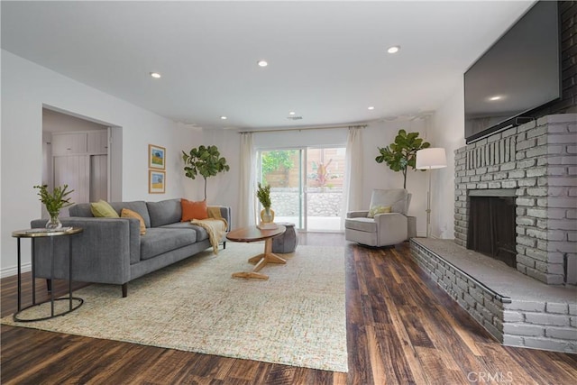 living area featuring a fireplace, recessed lighting, and wood finished floors