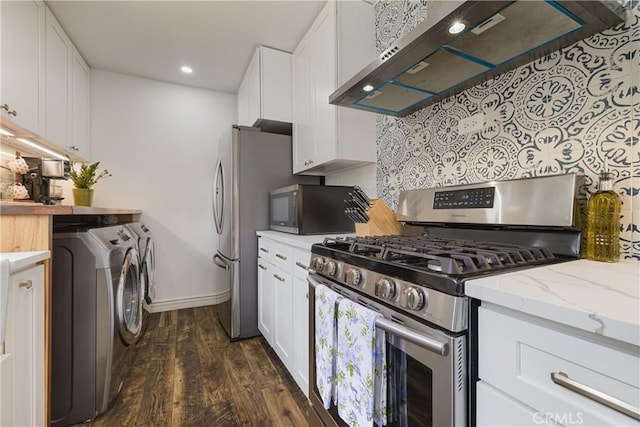 kitchen featuring washer and dryer, dark wood-type flooring, white cabinetry, under cabinet range hood, and stainless steel appliances