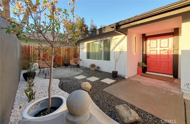1427 N Cannon St, Orange, CA 92869 - view of exterior entry with a patio, fence, and stucco siding