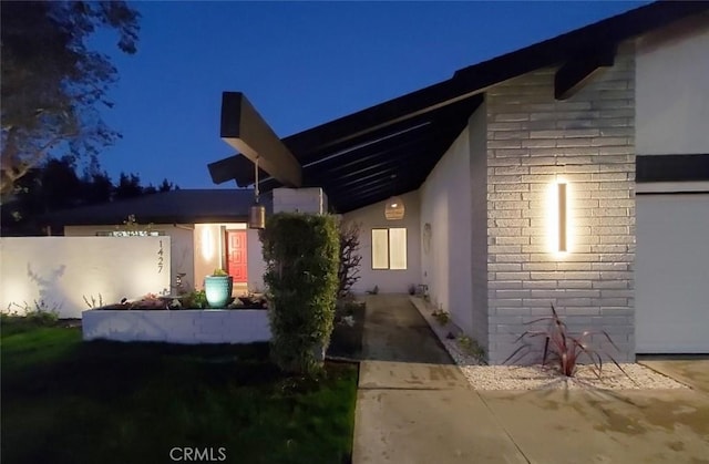 1427 N Cannon St, Orange, CA 92869 - property exterior at twilight featuring brick siding and stucco siding