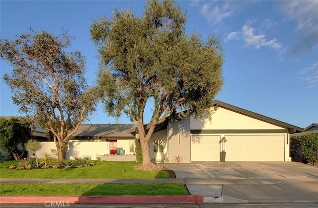 1427 N Cannon St, Orange, CA 92869 - single story home with stucco siding, driveway, a front lawn, and a garage