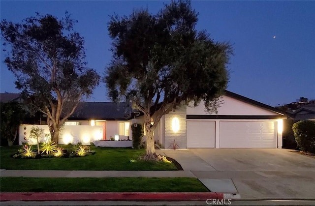 1427 N Cannon St, Orange, CA 92869 - ranch-style house featuring a yard, an attached garage, driveway, and stucco siding