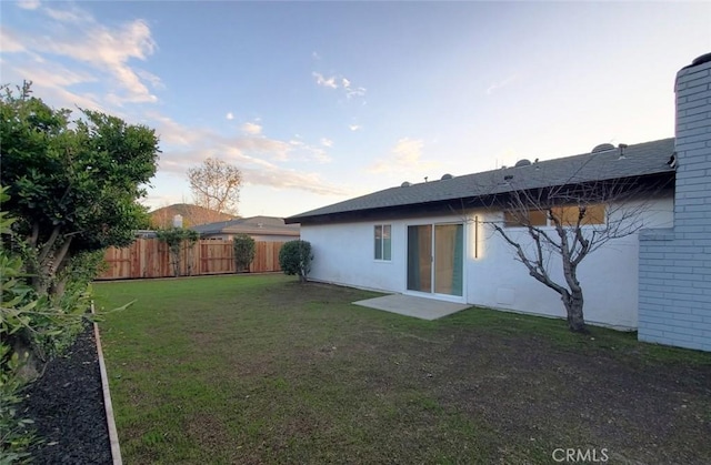 1427 N Cannon St, Orange, CA 92869 - back of property with fence, brick siding, stucco siding, a chimney, and a lawn