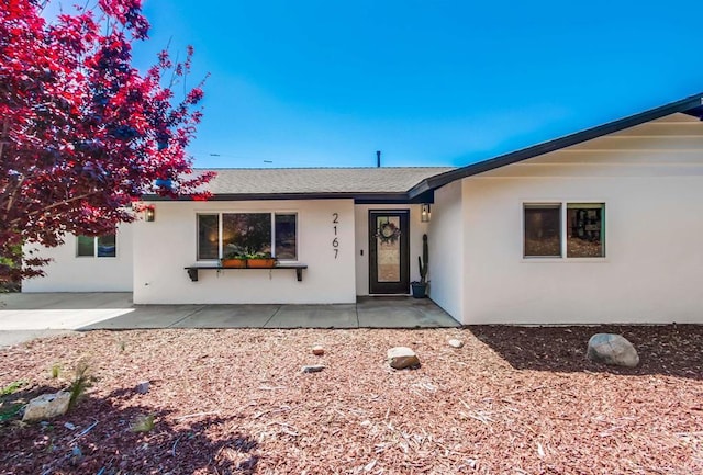 ranch-style home featuring a patio and stucco siding