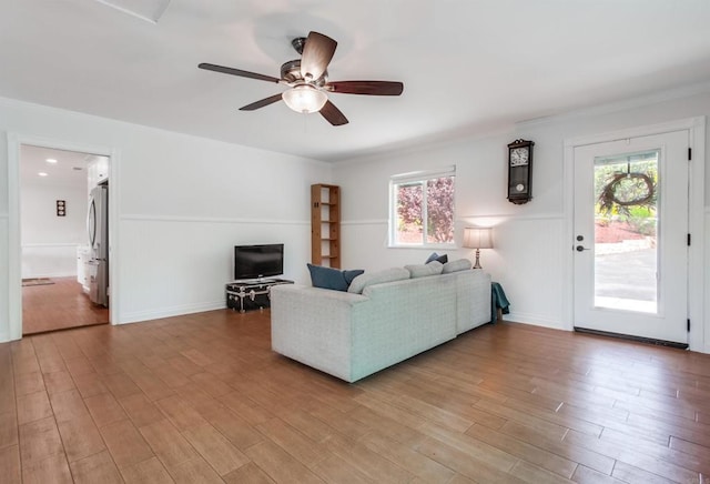 living area with ceiling fan and light wood-type flooring