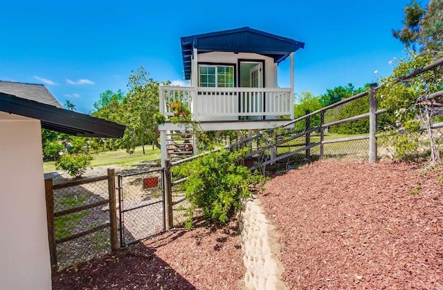 exterior space with fence, a gate, and stairs