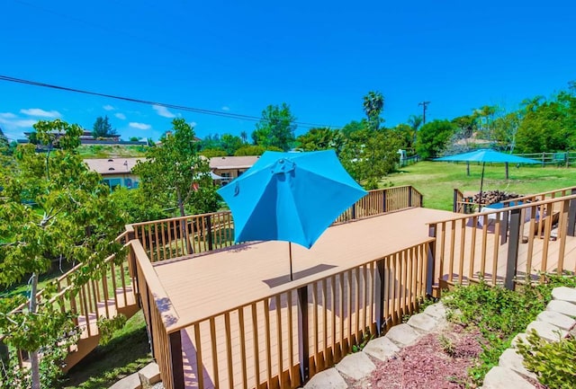 deck featuring a lawn and fence