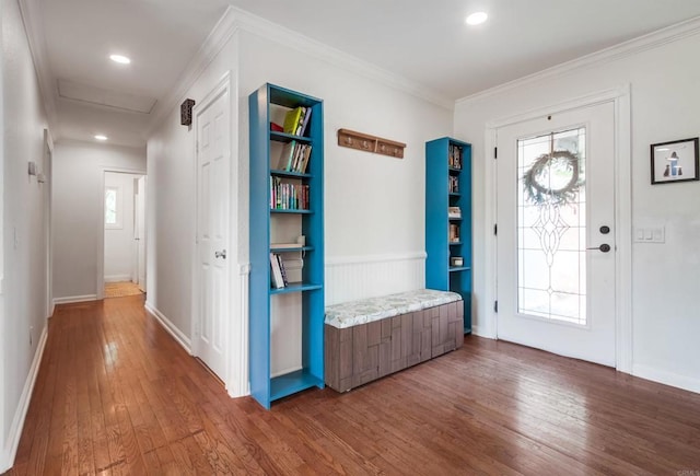 entryway featuring wood-type flooring, baseboards, and crown molding