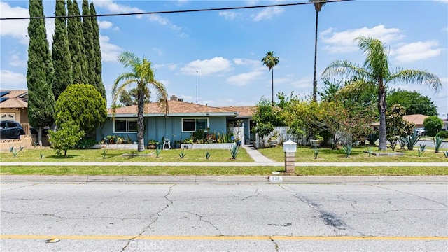 931 N Eucalyptus Ave, Rialto, CA 92376 - view of front of home featuring a front lawn and board and batten siding