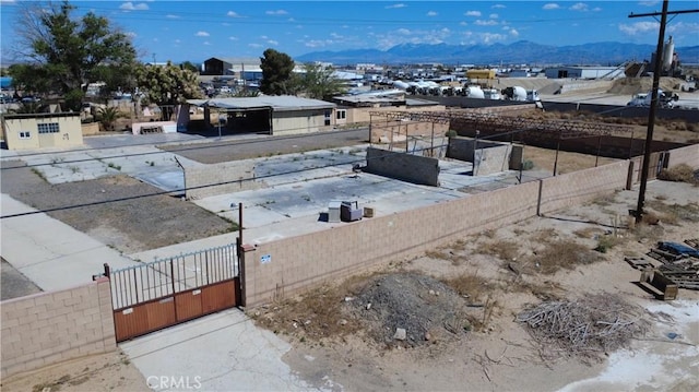 view of yard with a gate, a mountain view, and fence private yard