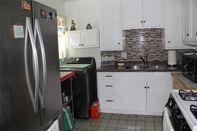 12018 169th St, Artesia, CA 90701 - kitchen with freestanding refrigerator, washer / dryer, range with gas stovetop, white cabinetry, and tile patterned floors