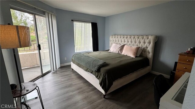 1980 Las Colinas Cir Unit 208, Corona, CA 92879 - bedroom featuring access to exterior, multiple windows, wood finished floors, and baseboards