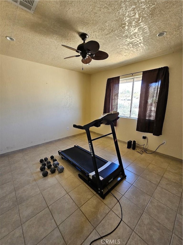 61391 Alta Vista Dr, Joshua Tree, CA 92252 - workout room featuring ceiling fan, a textured ceiling, and tile patterned floors