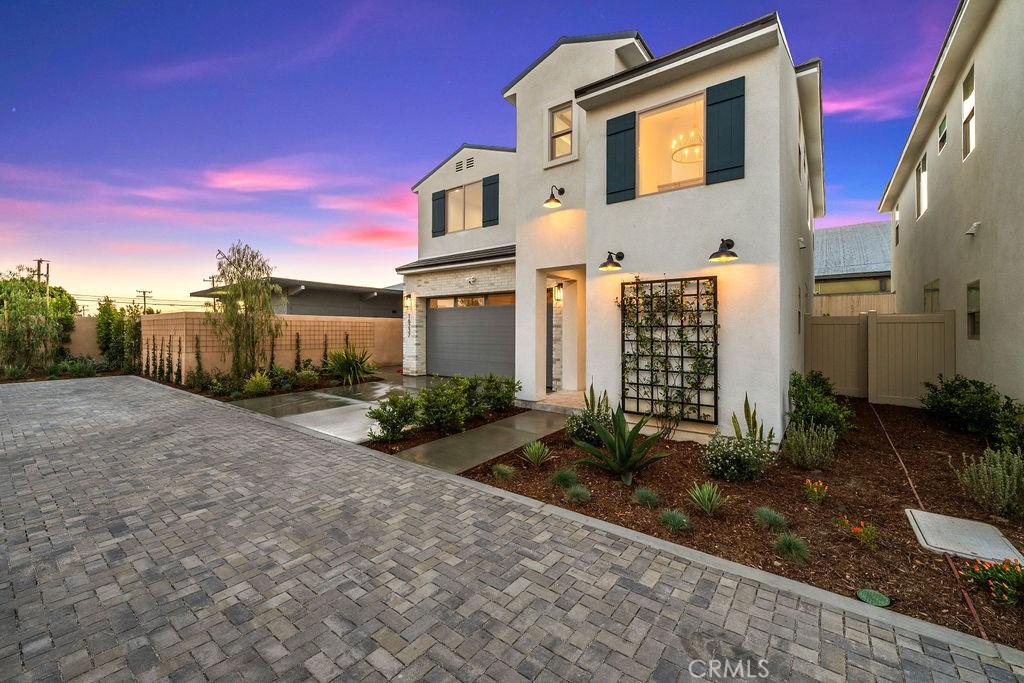 view of front of home featuring fence, an attached garage, driveway, and stucco siding