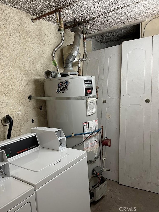 laundry area featuring strapped water heater and washing machine and dryer