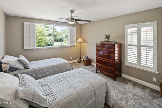 carpeted bedroom featuring a ceiling fan and baseboards