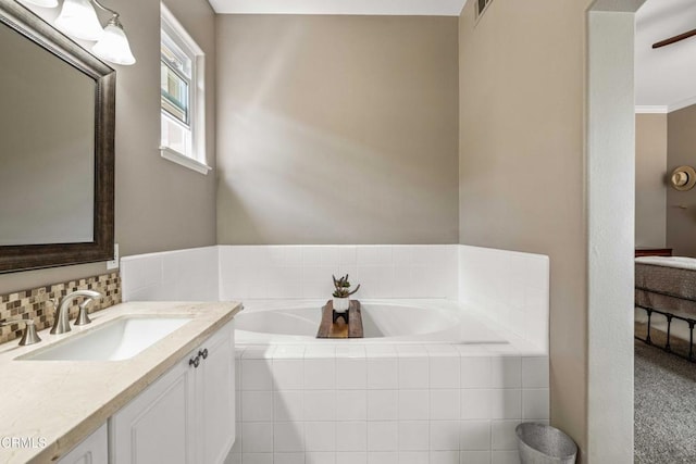 bathroom with vanity, a bath, and visible vents