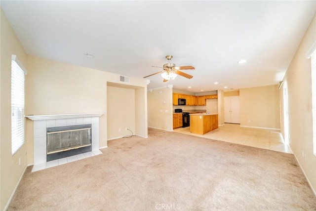 32057 Meadow Wood Ln, Lake Elsinore, CA 92532 - unfurnished living room featuring a fireplace, light carpet, ceiling fan, baseboards, and recessed lighting