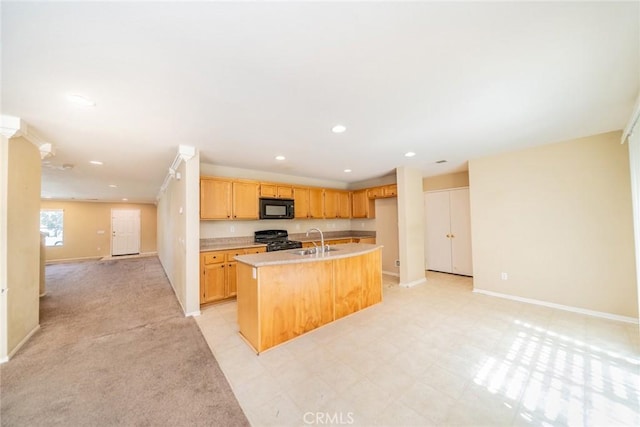 32057 Meadow Wood Ln, Lake Elsinore, CA 92532 - kitchen featuring black appliances, a sink, a kitchen island with sink, light countertops, and baseboards