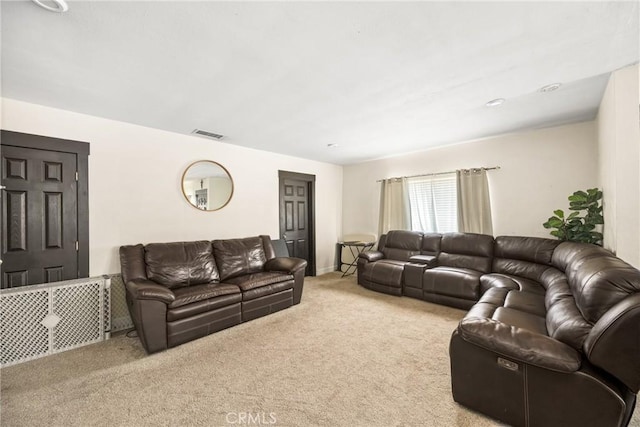 carpeted living room with baseboards and visible vents