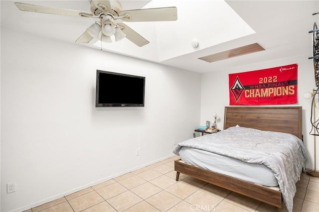 tiled bedroom featuring a ceiling fan and baseboards