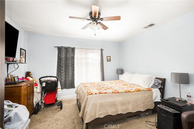 bedroom featuring a ceiling fan, baseboards, visible vents, and carpet