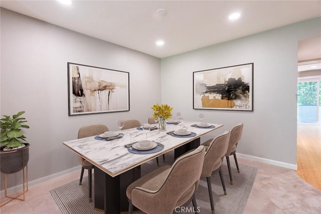 dining area with baseboards, light carpet, and recessed lighting