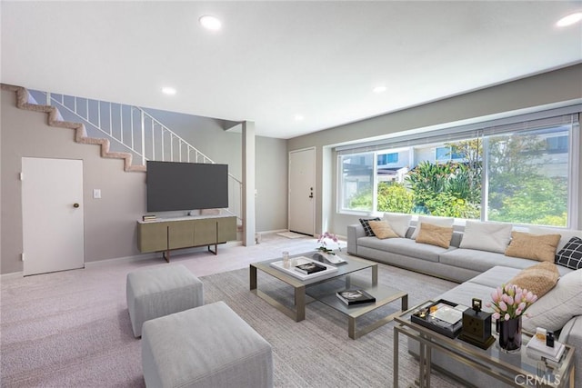 living area with light colored carpet, recessed lighting, and stairway