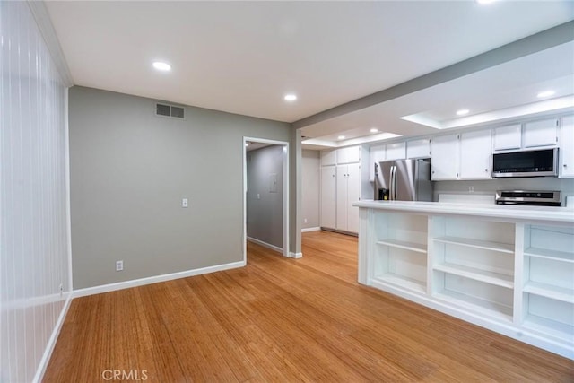 kitchen with recessed lighting, open shelves, appliances with stainless steel finishes, and visible vents
