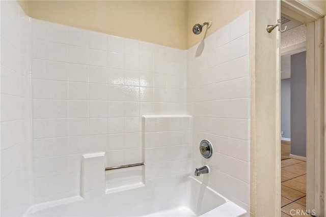 bathroom featuring shower / tub combination and tile patterned flooring
