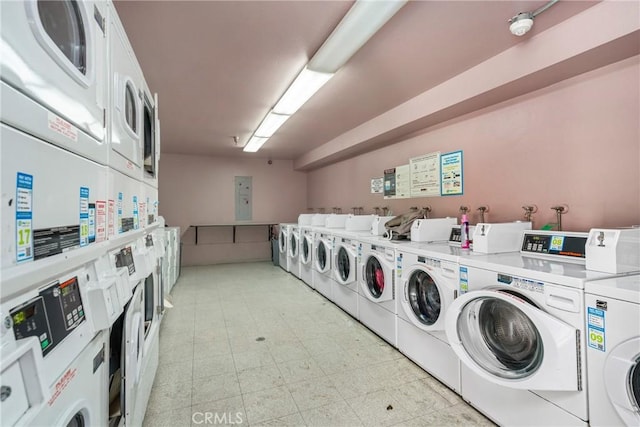 community laundry room with stacked washer / drying machine and washer and clothes dryer