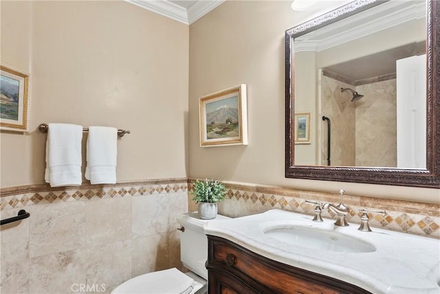 bathroom with wainscoting, vanity, toilet, tile walls, and ornamental molding