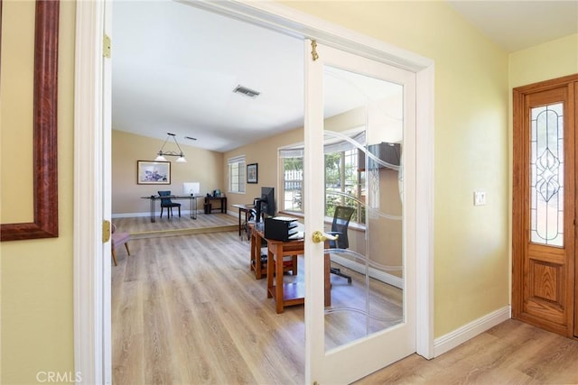 entryway featuring light wood-style flooring and baseboards