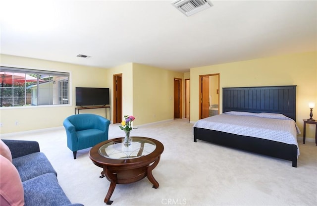 bedroom with light colored carpet and baseboards