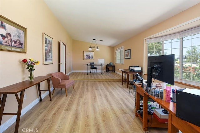 living room featuring an office area, light wood-style floors, and baseboards