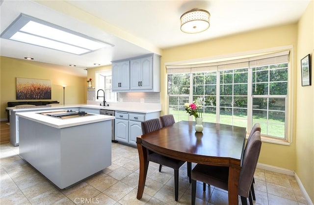 kitchen with light countertops, black electric cooktop, and healthy amount of natural light