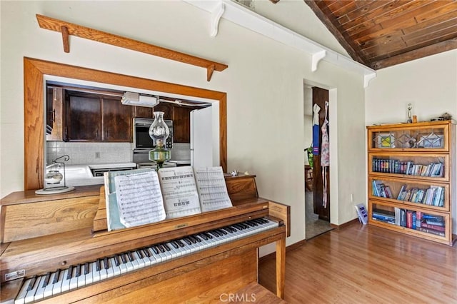 interior space featuring baseboards, wood ceiling, lofted ceiling, and wood finished floors