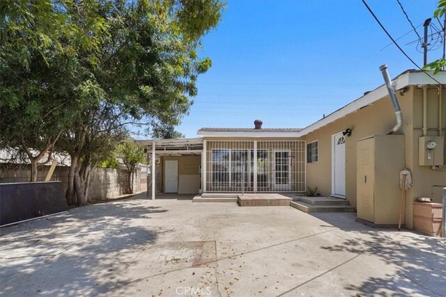 9451 Canterbury Ave, Arleta, CA 91331 - back of property with a patio, fence, and stucco siding