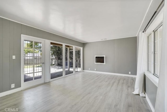 9451 Canterbury Ave, Arleta, CA 91331 - unfurnished living room with light wood-style flooring, baseboards, and heating unit