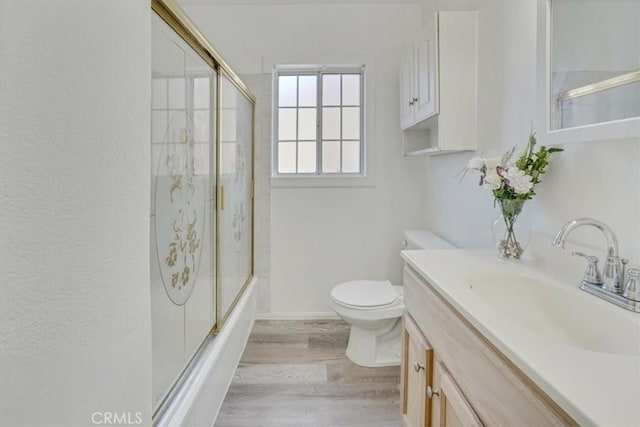 9451 Canterbury Ave, Arleta, CA 91331 - full bathroom featuring toilet, wood finished floors, vanity, and shower / bath combination with glass door