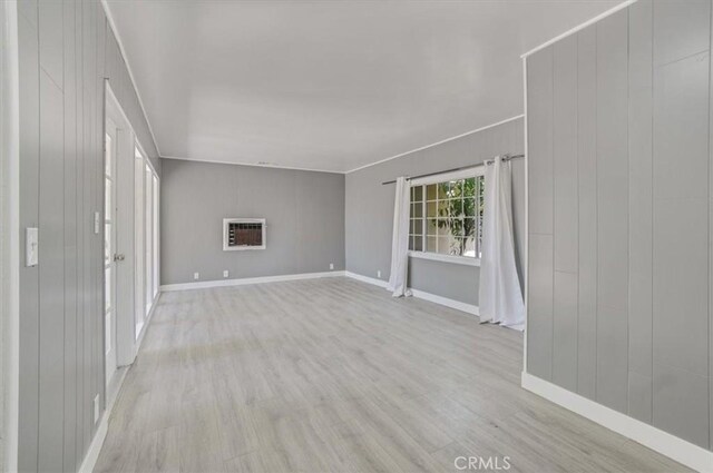 9451 Canterbury Ave, Arleta, CA 91331 - unfurnished living room featuring wood finished floors, baseboards, and heating unit