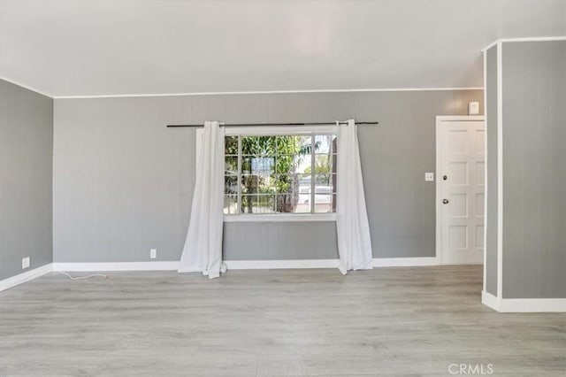 9451 Canterbury Ave, Arleta, CA 91331 - spare room featuring wood finished floors, baseboards, and wooden walls