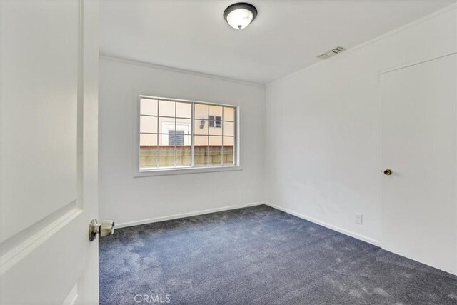 9451 Canterbury Ave, Arleta, CA 91331 - unfurnished room with dark colored carpet, ornamental molding, and baseboards