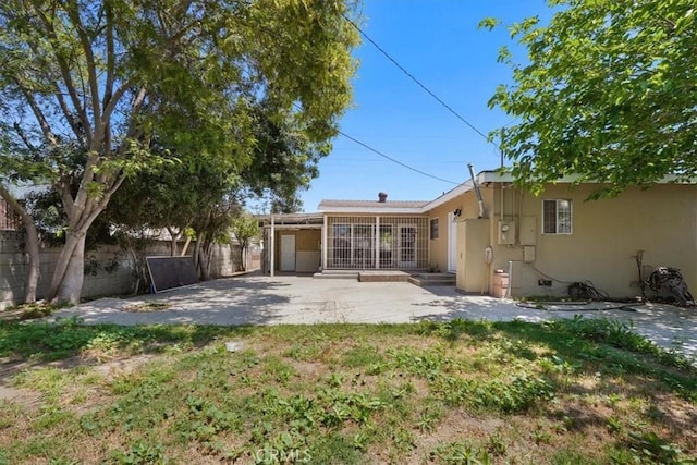 9451 Canterbury Ave, Arleta, CA 91331 - rear view of property with fence, a patio, and stucco siding