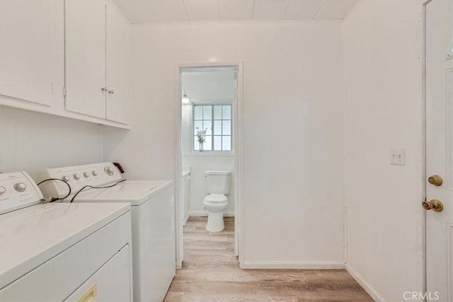 9451 Canterbury Ave, Arleta, CA 91331 - laundry area featuring washer and clothes dryer, light wood-style flooring, cabinet space, ornamental molding, and baseboards