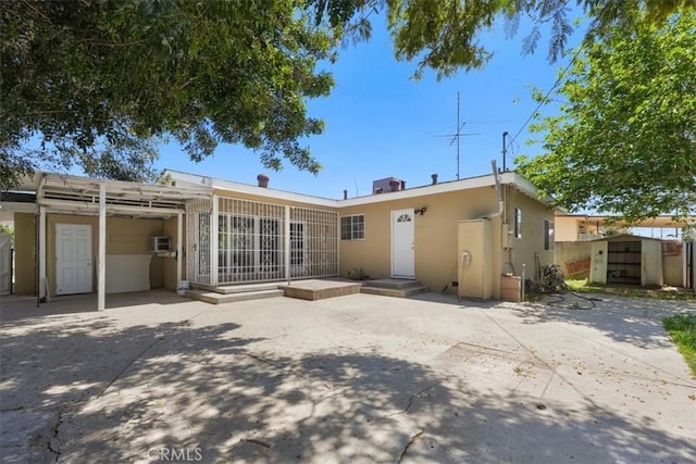 9451 Canterbury Ave, Arleta, CA 91331 - rear view of property featuring stucco siding and a patio