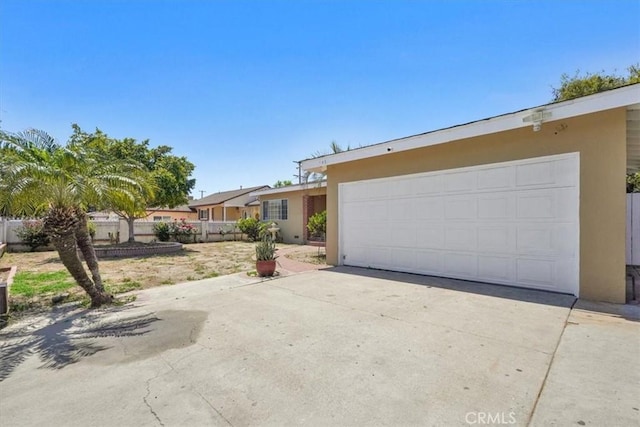 9451 Canterbury Ave, Arleta, CA 91331 - single story home featuring stucco siding, driveway, an attached garage, and fence