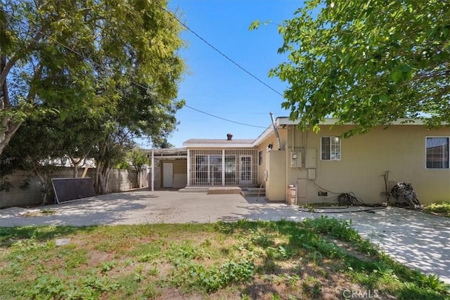 9451 Canterbury Ave, Arleta, CA 91331 - rear view of house featuring stucco siding, a patio area, and fence